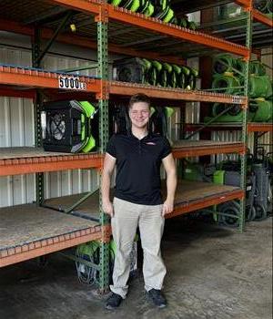 A Man standing in front of a wall of air mover fans