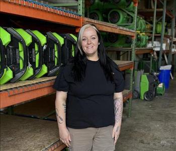 A Woman standing in front of a wall of air movers