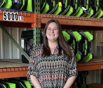 A Woman standing in front of a wall of air movers