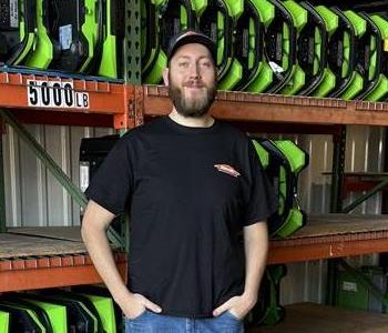 A Man standing in front of a wall of air mover fans